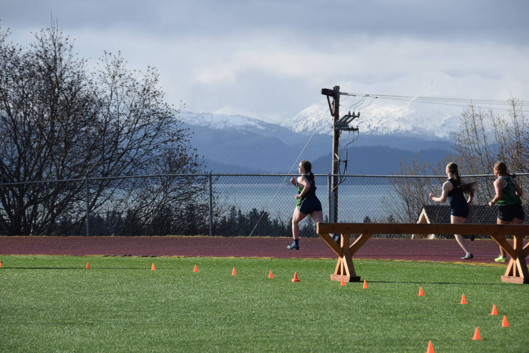 The sun peeks out during the girls steeplechase event on Friday, April 18 at the Homer High School Invitational Track Meet. (Chloe Pleznac/Homer News)
