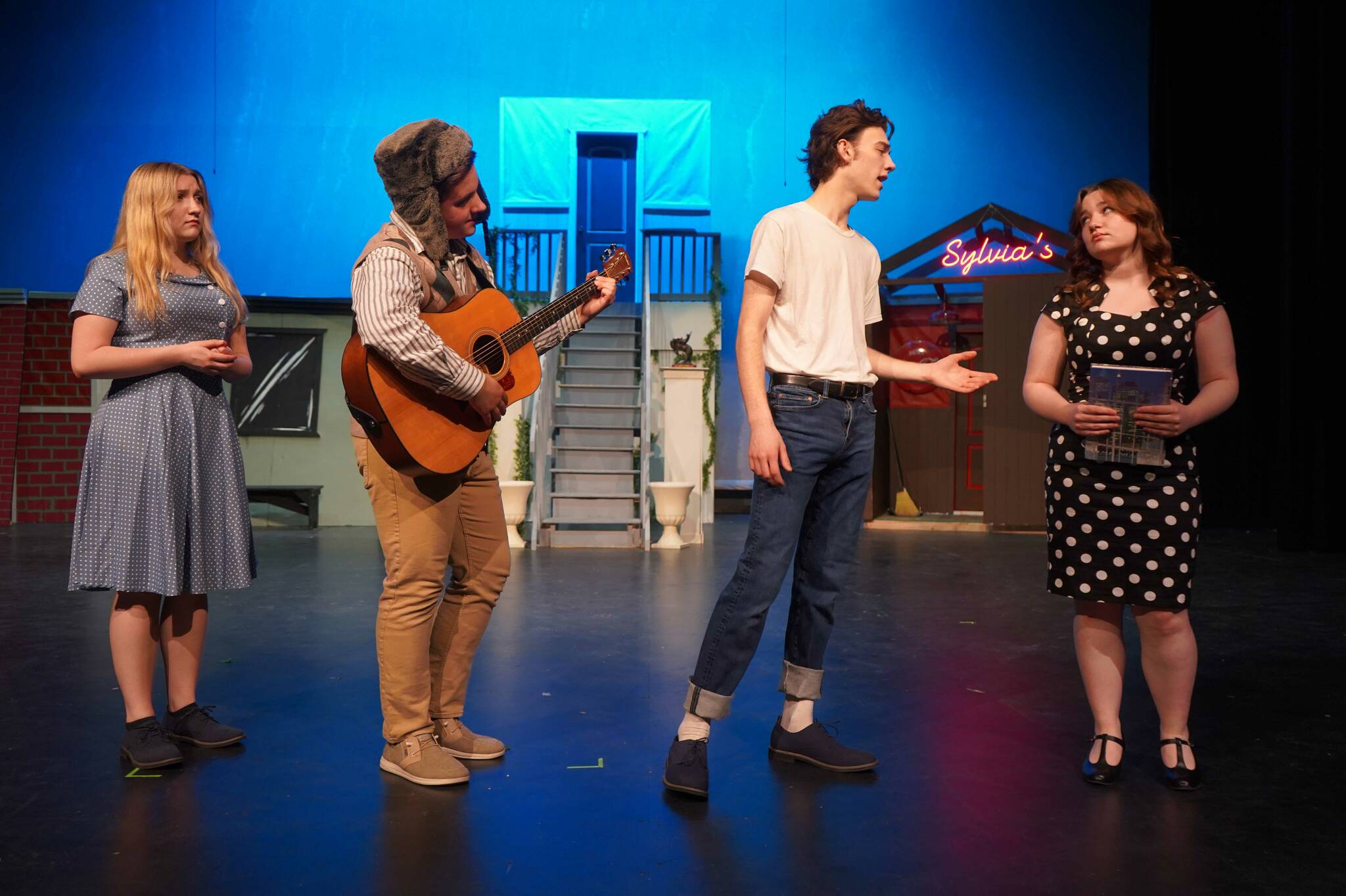 Belle Morris, Jackson Hooper, Kyler Allen and Oshie Broussard rehearse “All Shook Up” in the Nikiski Middle/High School Auditorium on Saturday, April 26, 2025. (Jake Dye/Peninsula Clarion)