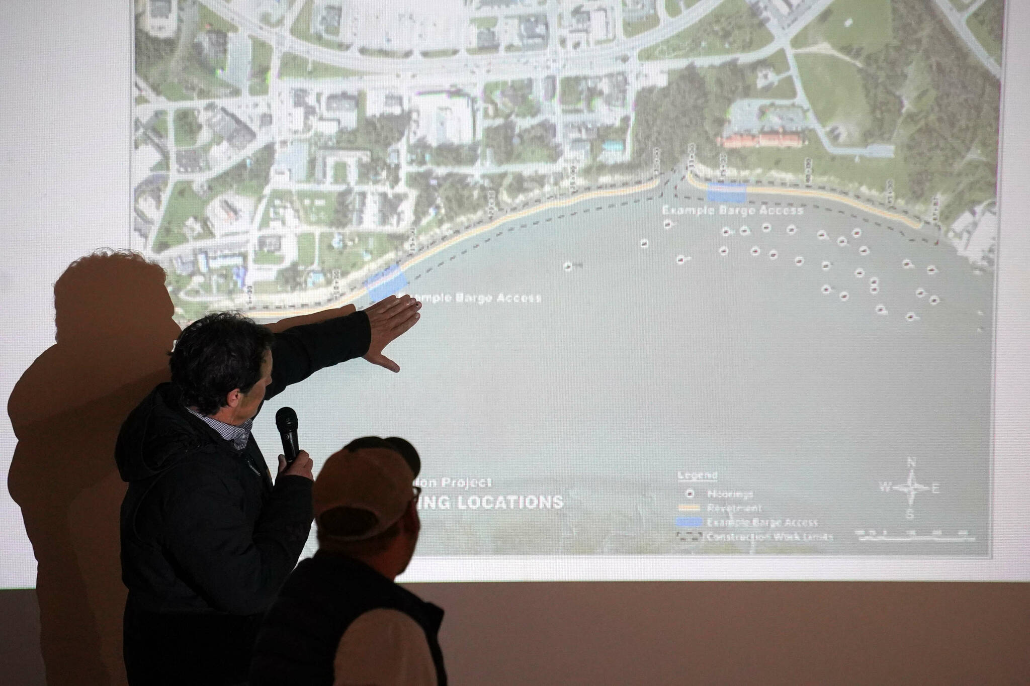 Project Manager Jerrod Stafford, of Western Marine Construction, points to a map of the Kenai River Bluff Stabilization Project while giving an update on the project in Kenai, Alaska, on Wednesday, April 30, 2025. (Jake Dye/Peninsula Clarion)