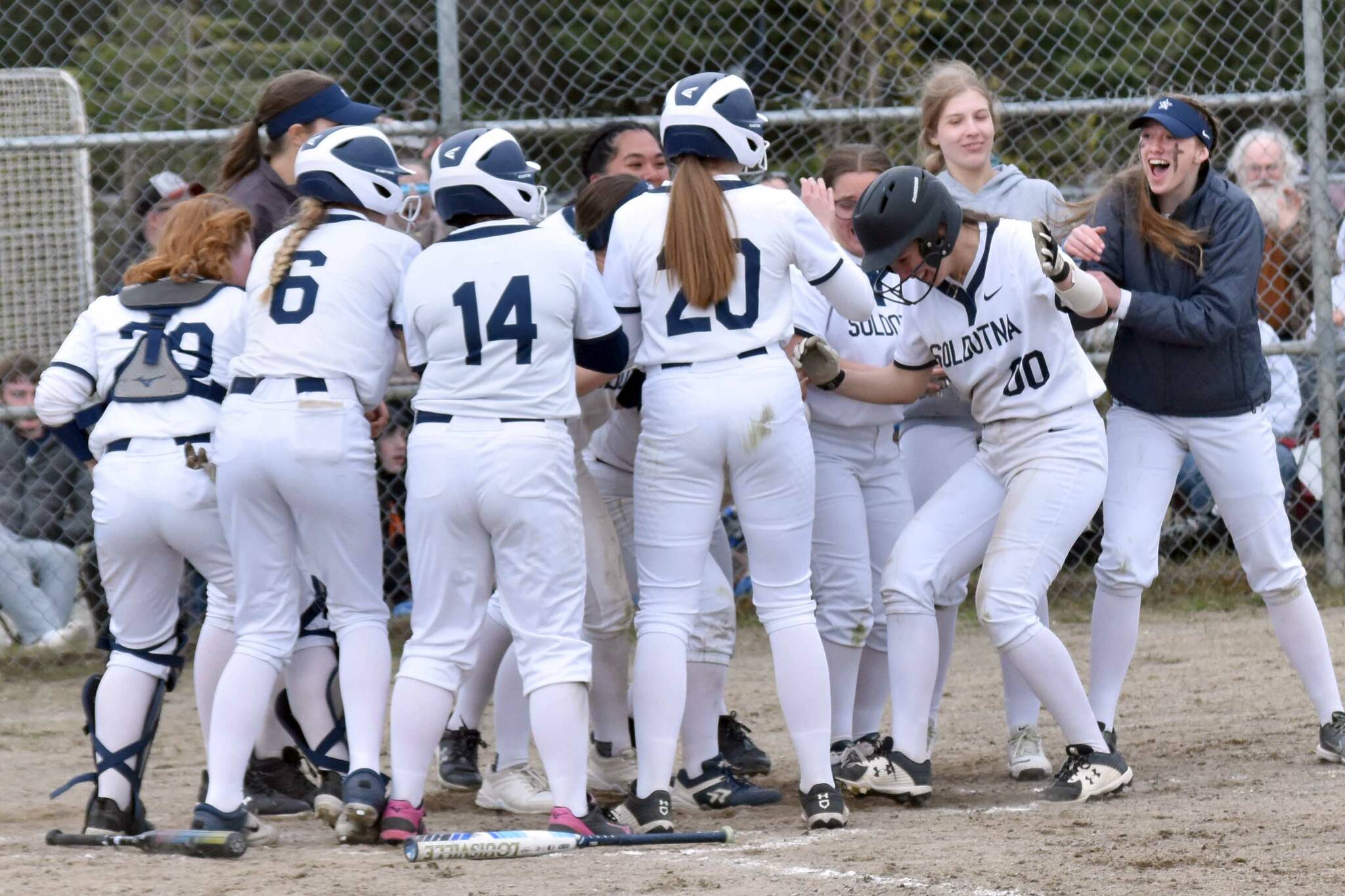 Juliet Innes (00) and Soldotna celebrate a home run by Innes against Homer on Monday, May 5, 2025, at the Soldotna Little League fields in Soldotna, Alaska. (Photo by Jeff Helminiak/Peninsula Clarion)