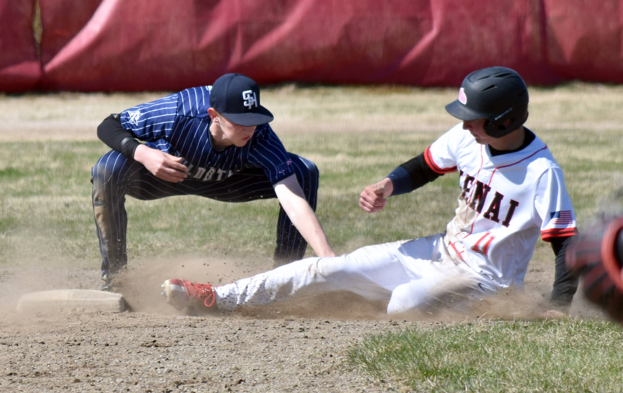 Soldotna second baseman Brett Hostetler tags out Kenai Central's Braden Smith on Saturday, May 10, 2025, at the Kenai Little League fields in Kenai, Alaska. (Photo by Jeff Helminiak/Peninsula Clarion)