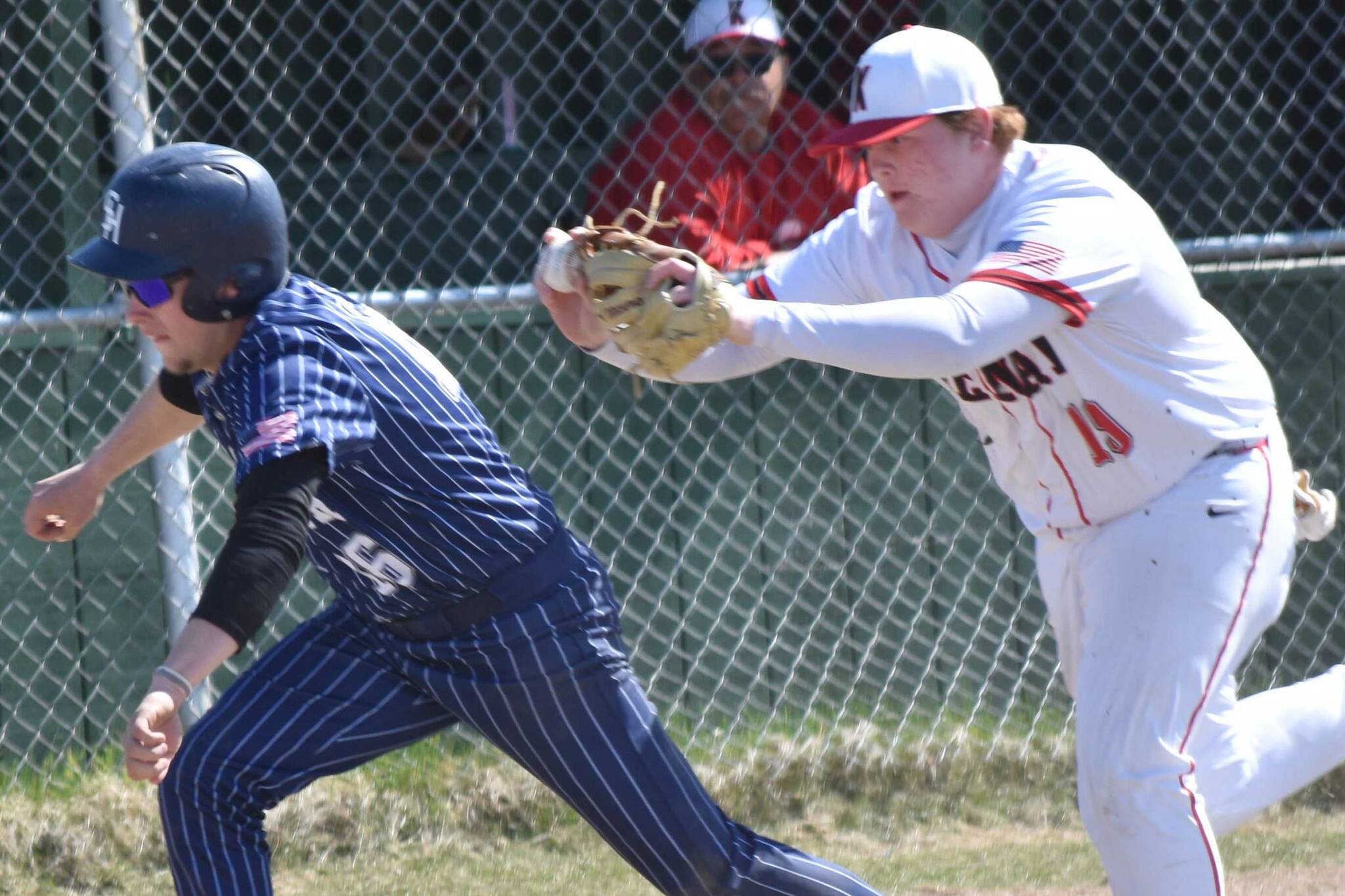 Kenai Central third baseman Blake Morris tags out Soldotna's Easton Hawkins on Saturday, May 10, 2025, at Kenai Little League fields in Kenai, Alaska. (Photo by Jeff Helminiak/Peninsula Clarion)