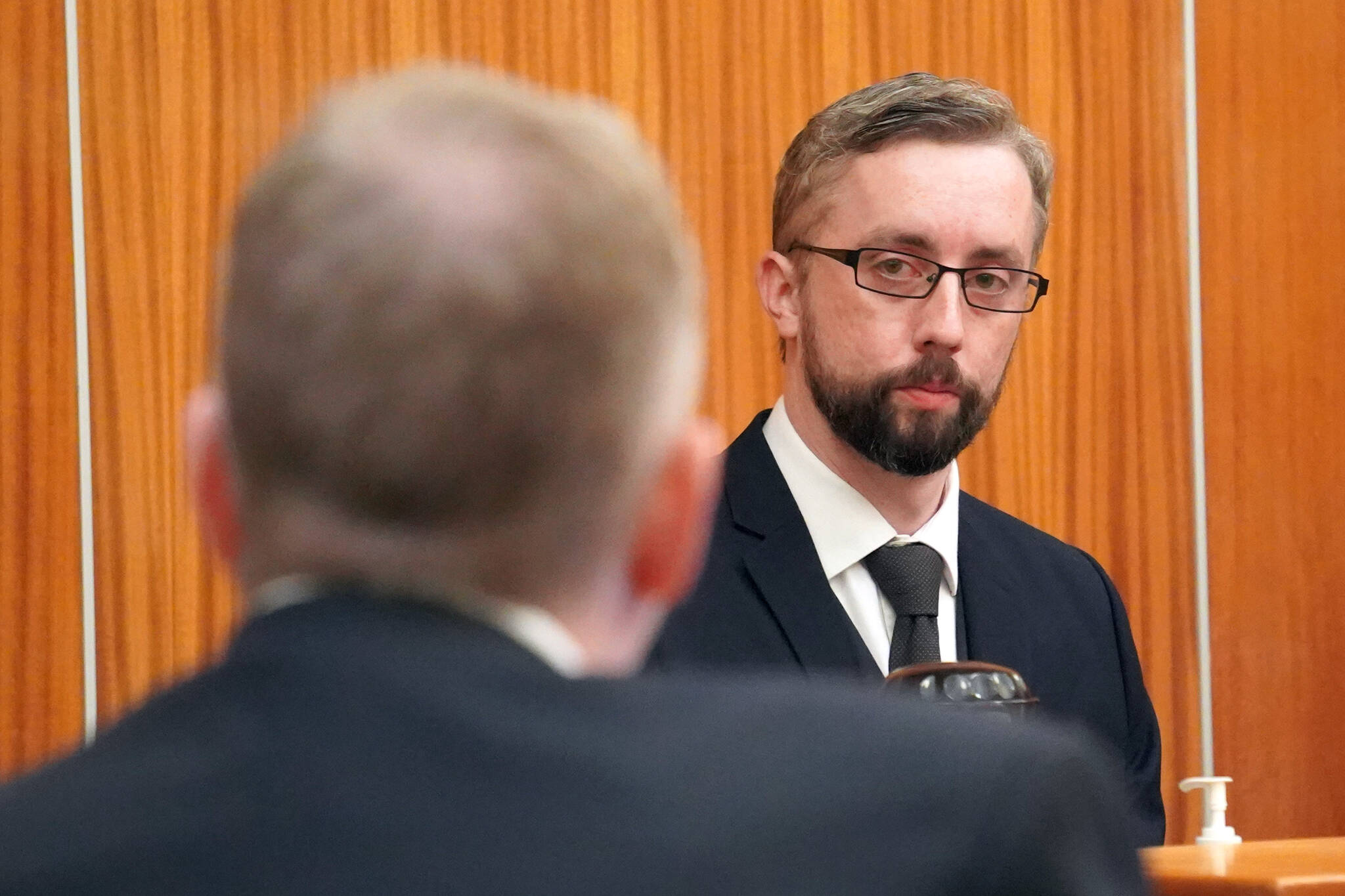 Nathan Erfurth, right, responds to questions from his attorney Eric Derleth during a hearing at the Kenai Courthouse in Kenai, Alaska, on April 12, 2024. (Jake Dye/Peninsula Clarion)