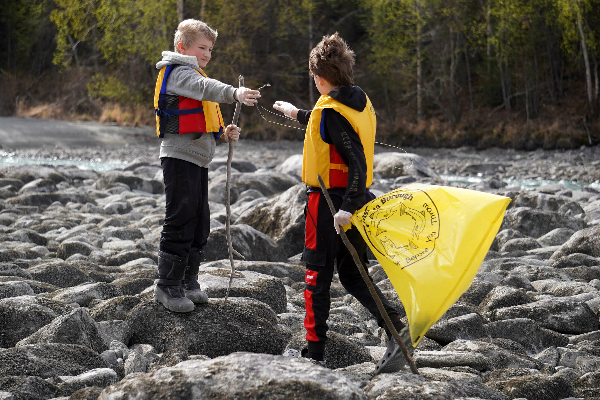 Sterling Elementary School students collect trash from the banks of the Kenai River near Bing’s Landing in Sterling, Alaska, during the 10th Annual Kenai River Spring Cleanup on Wednesday, May 14, 2025. (Jake Dye/Peninsula Clarion)