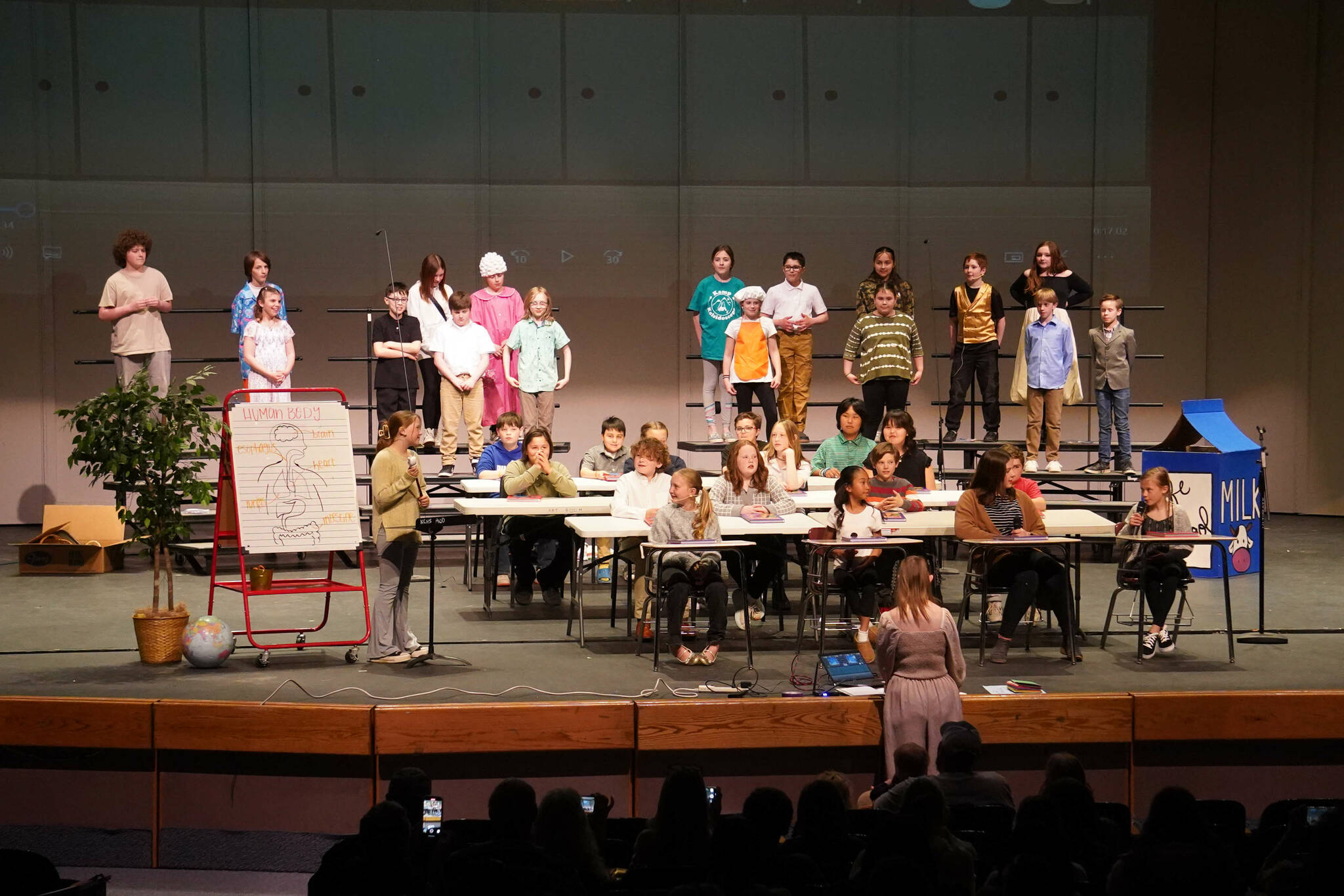 Kaleidoscope School of Arts and Science students perform “Let’s Eat,” their fifth grade musical, at Kenai Central High School in Kenai, Alaska, on Tuesday, May 13, 2025. (Jake Dye/Peninsula Clarion)