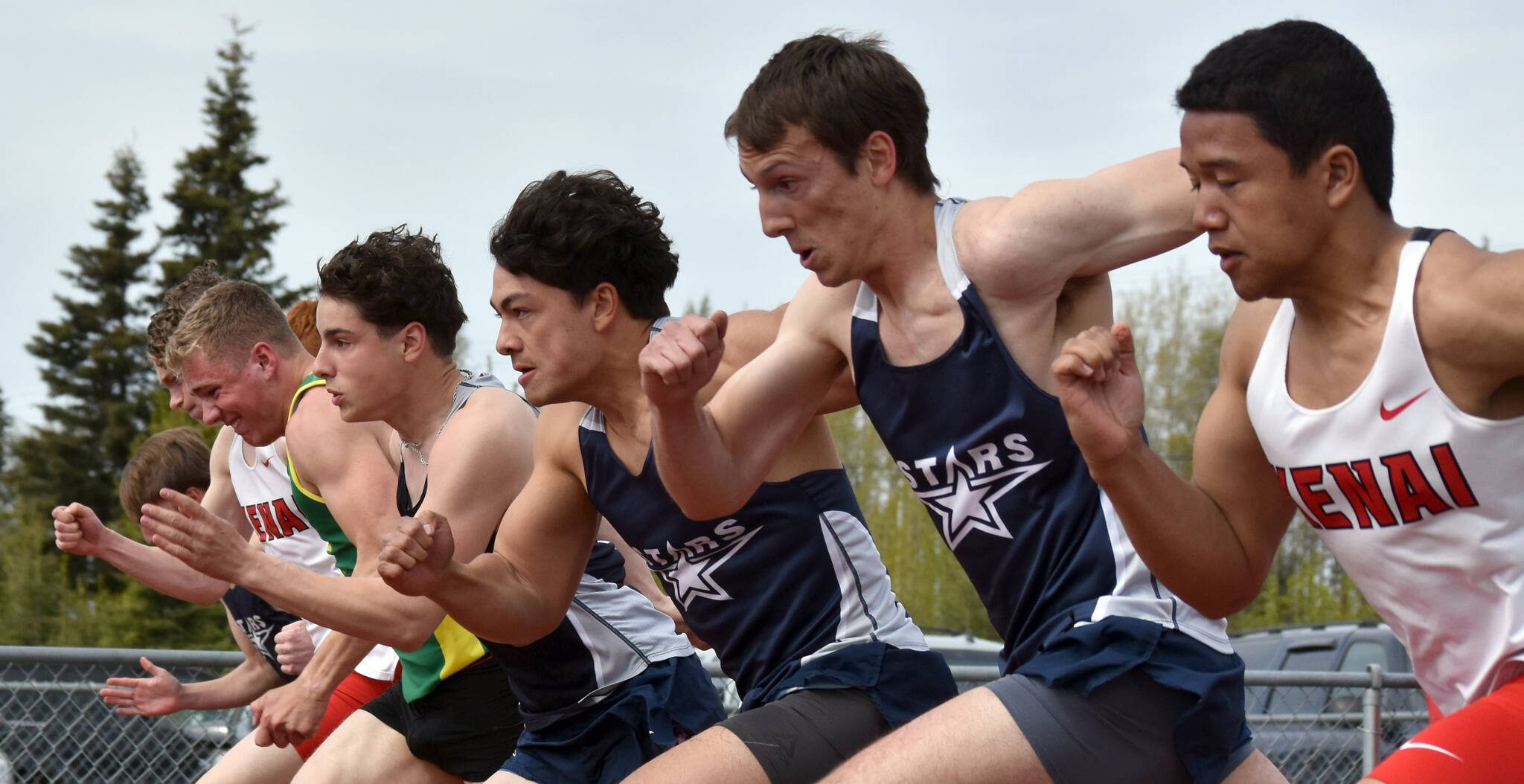The boys 100-meter dash field bolts from the starting blocks Saturday, May 17, 2025, at the Kenai Peninsula Borough meet at Ed Hollier Field at Kenai Central High School in Kenai, Alaska. (Photo by Jeff Helminiak/Peninsula Clarion)