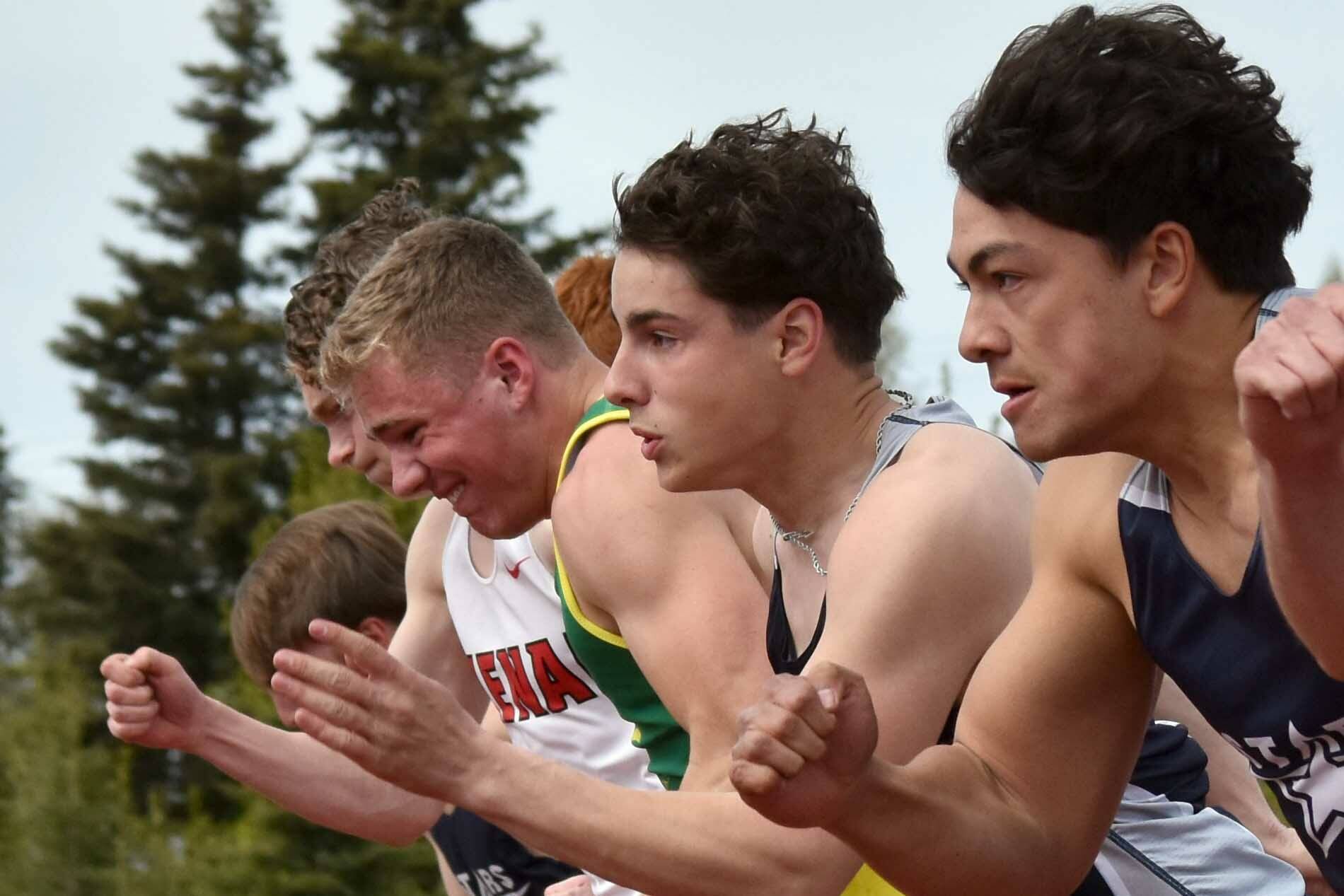 The boys 100-meter dash field bolts from the starting blocks Saturday, May 17, 2025, at the Kenai Peninsula Borough meet at Ed Hollier Field at Kenai Central High School in Kenai, Alaska. (Photo by Jeff Helminiak/Peninsula Clarion)
