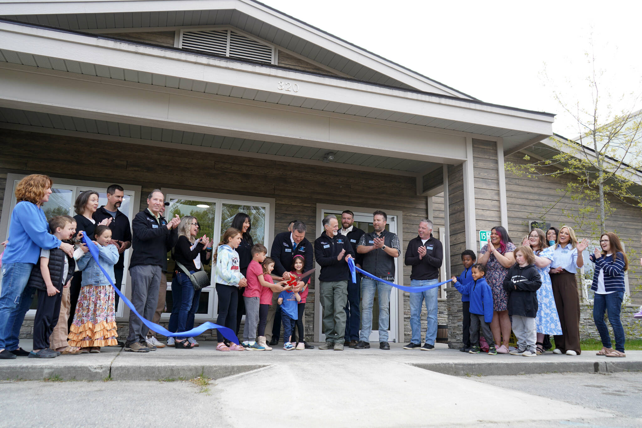 Jeff Dolifka and his children perform the ceremonial ribbon-cutting for the Boys and Girls Clubs of the Kenai Peninsula’s Royce and Melba Roberts Campus in Kenai, Alaska, on Saturday, May 17, 2025. (Jake Dye/Peninsula Clarion)