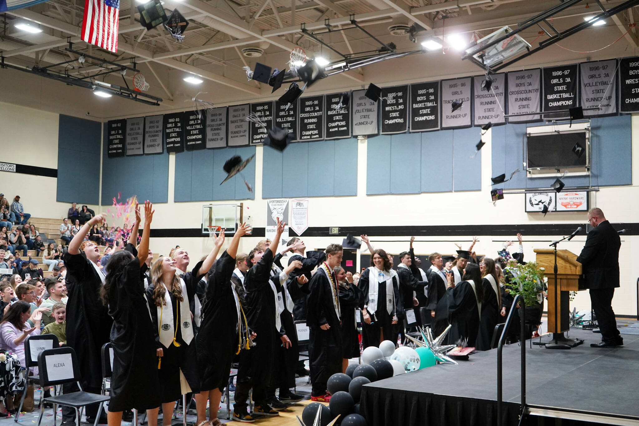 Nikiski graduates toss their caps at the end of a commencement ceremony at Nikiski/Middle High School in Nikiski, Alaska, on Monday, May 19, 2025. (Jake Dye/Peninsula Clarion)