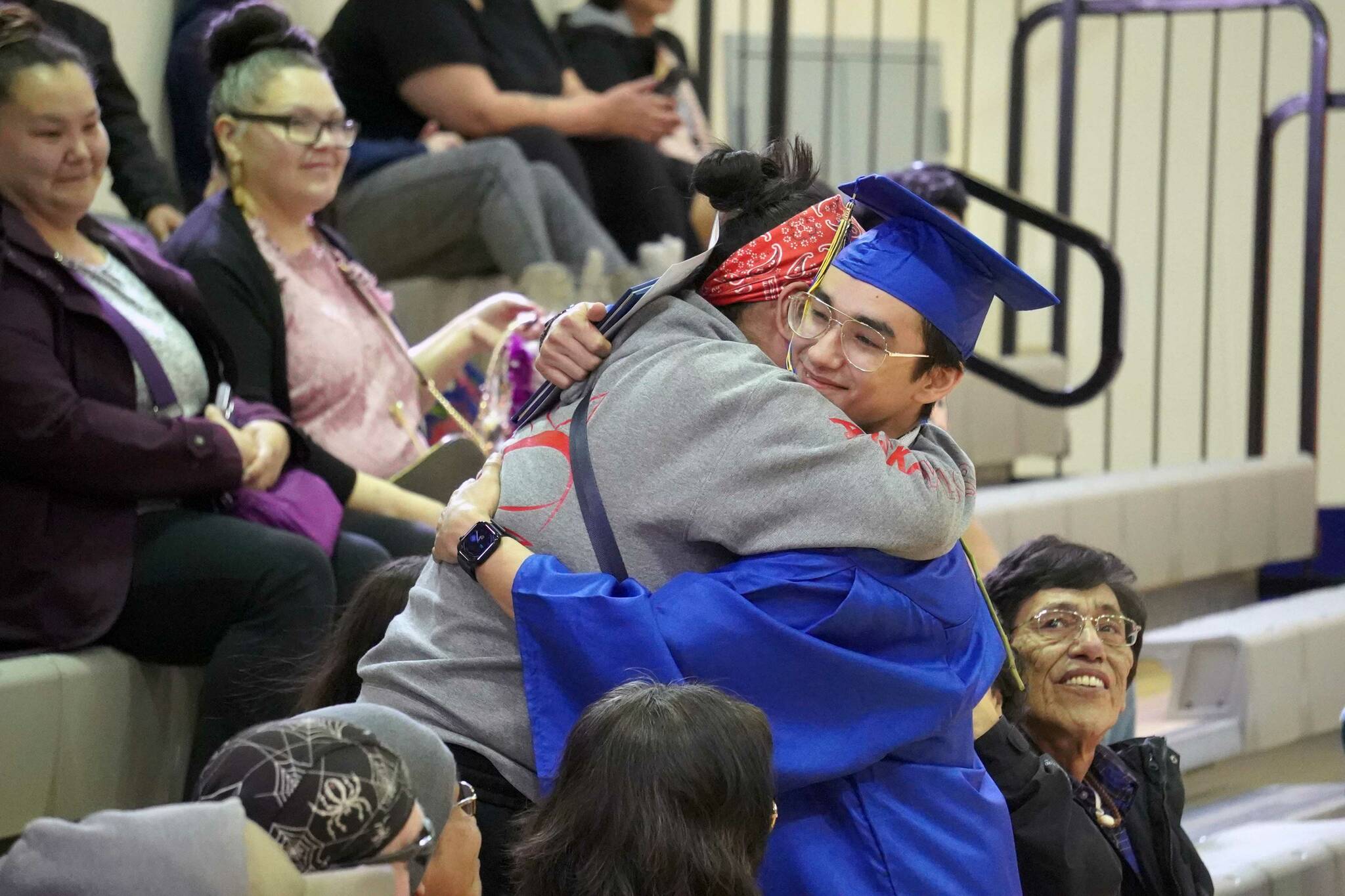 Kenai Alternative High School graduates embrace supporters during their commencement ceremony in the school’s gym in Kenai, Alaska, on Wednesday, May 22, 2025. (Jake Dye/Peninsula Clarion)
