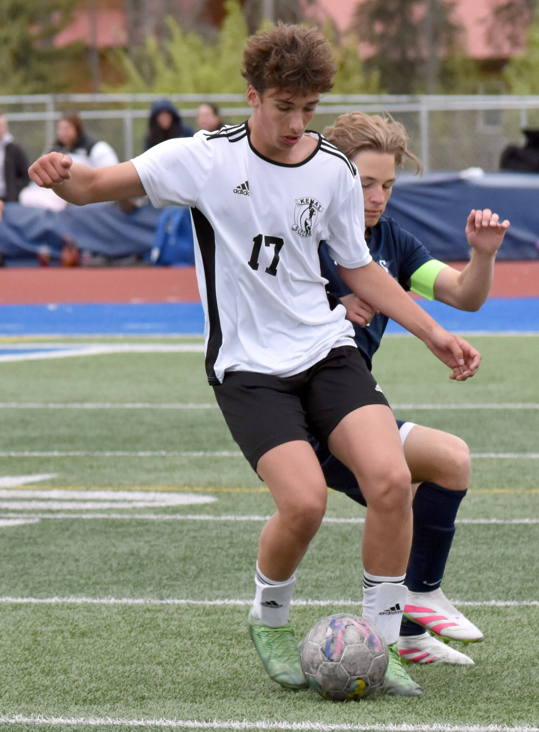 Kenai Central’s Brett Goldsby shields the ball from Soldotna’s Owen Buckbee on Thursday, May 22, 2025, at Justin Maile Field at Soldotna High School in Soldotna, Alaska. (Photo by Jeff Helminiak/Peninsula Clarion)