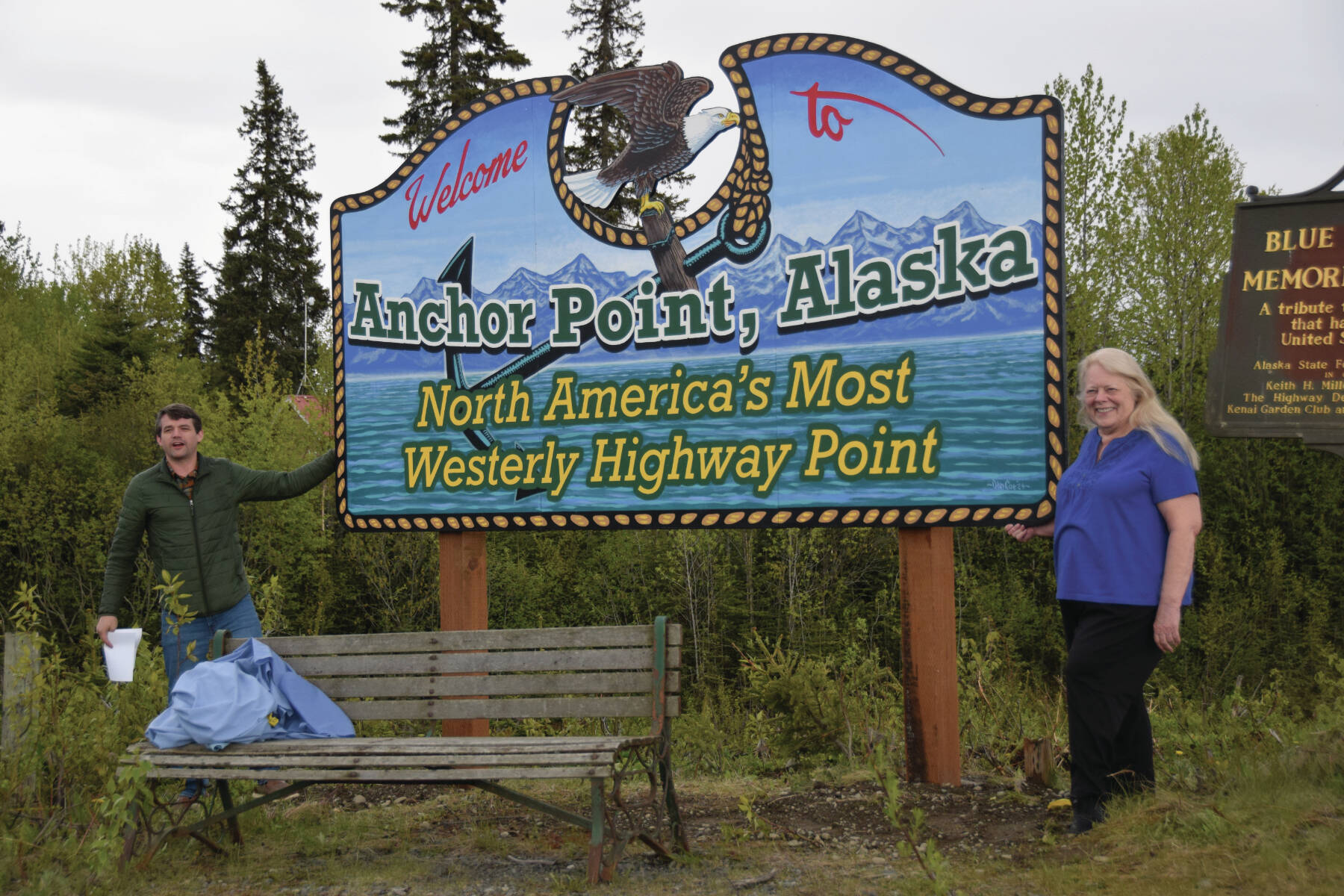 Anchor Point Chamber of Commerce President Dawson Slaughter (left) and Susie Myhill, co-owner of Anchor River Lodge and co-chair for the chamber’s sign committee, unveil the new “most westerly highway point” sign on Tuesday in Anchor Point. (Delcenia Cosman/Homer News)