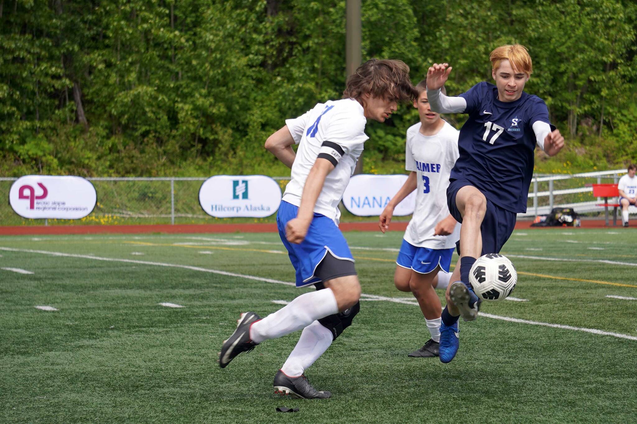 Soldotna’s Lane Hillyer moves with the ball against opposition by Palmer’s Jacob Logan during the final match of the ASAA Division II Boys Soccer Championship at Wasilla High School in Wasilla, Alaska, on Saturday, May 31, 2025. (Jake Dye/Peninsula Clarion)
