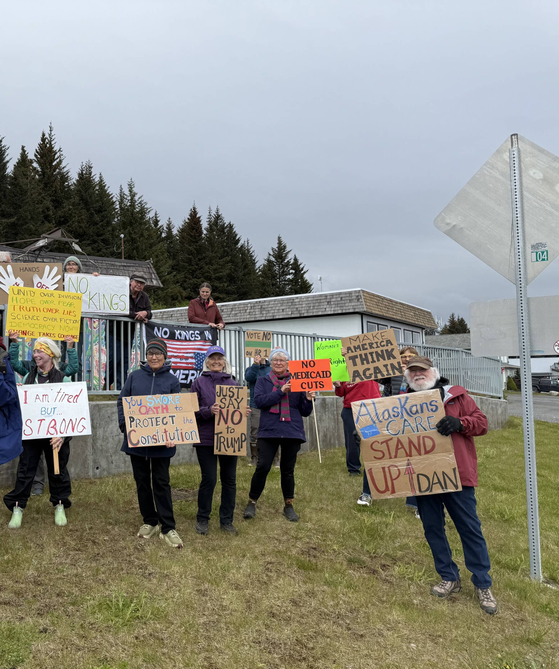 Demonstrators stand on the corner of Pioneer Avenue and Svedlund Street in Homer, Alaska on Friday, May 30. They hoped to catch Senator Sullivan’s attention as he drove by to attend a private meeting at the Homer Senior Citizens Center.
