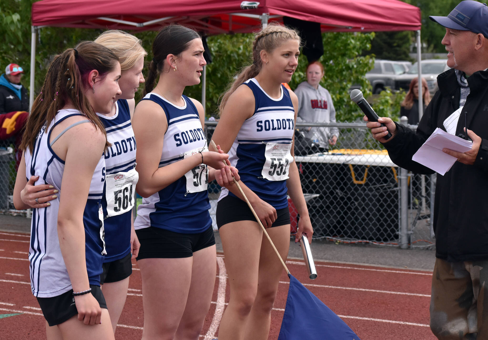 Soldotna’s Shiloh Zichko, Sophia Jedlicki, Anaulie Sedivy and Sarah Brown inform the announcer they also set a school record after winning a state title in the 400-meter relay Saturday, May 31, 2025, at the Division I state track meet at Dimond High School in Anchorage, Alaska. (Photo by Jeff Helminiak/Peninsula Clarion)