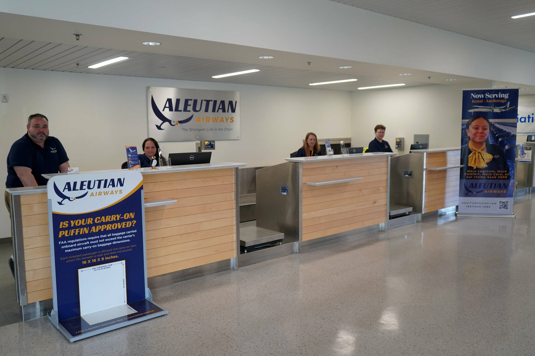 Aleutian Airways staff fill the desk during their first day of service at Kenai Municipal Airport in Kenai, Alaska, on Friday, June 6, 2025. (Jake Dye/Peninsula Clarion)