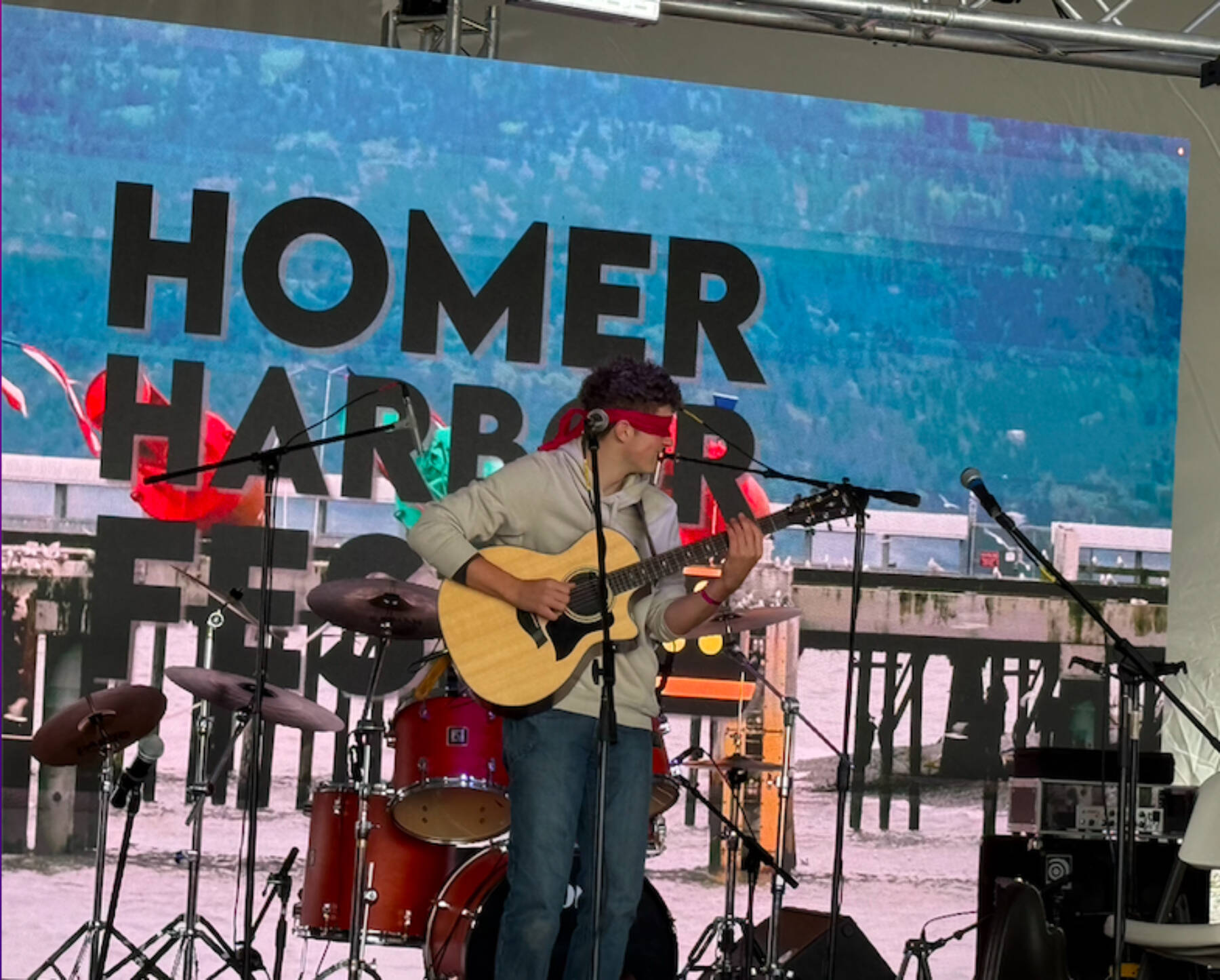 Local musician Silas Luke Jones performs blindfolded during his performance at the inaugural HomerFest on the Homer Spit on Saturday. (Chloe Pleznac/Homer News)