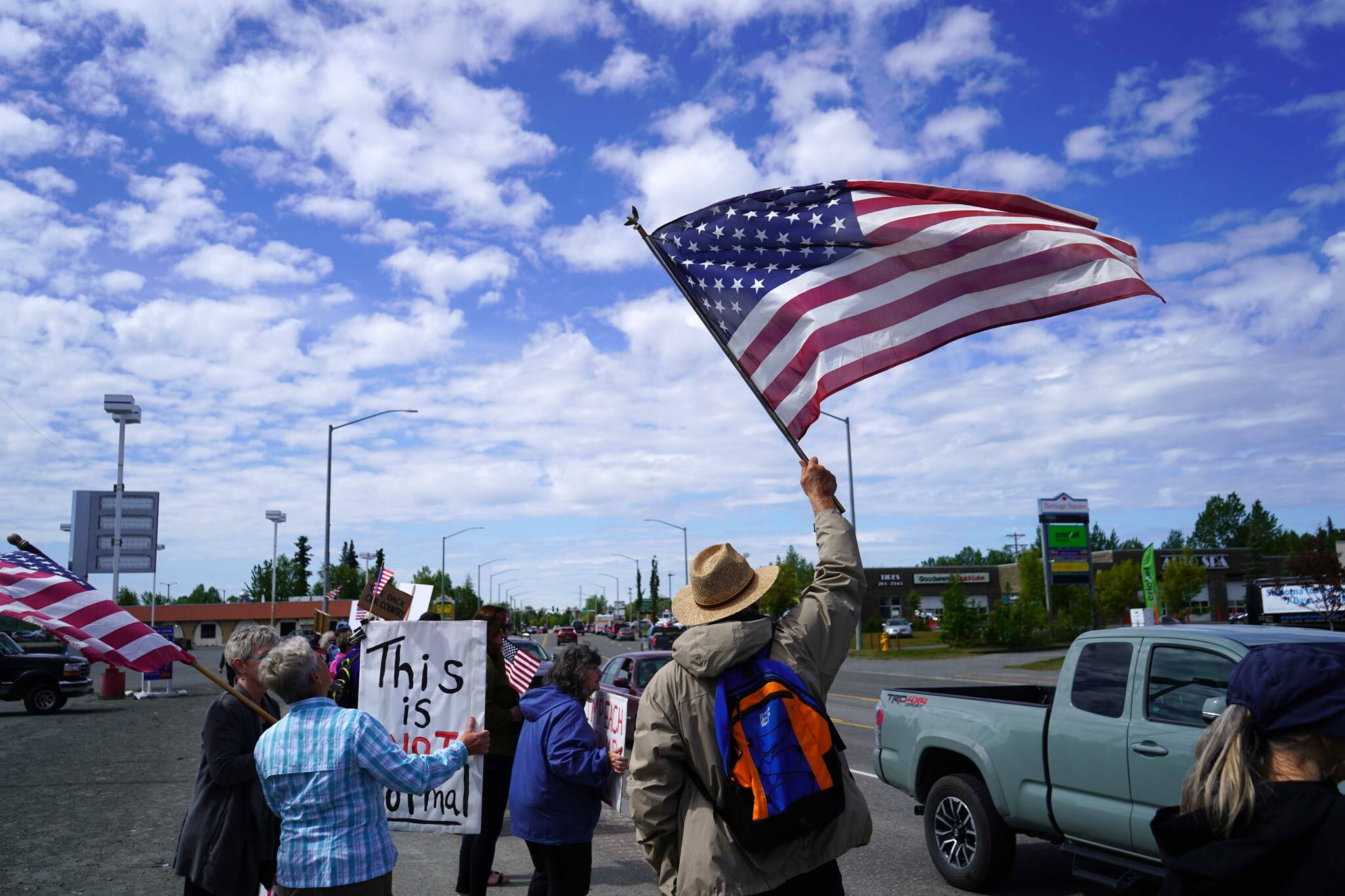 People carrying flags and signs line the Sterling Highway for a “No Kings” protest in Soldotna, Alaska, on Saturday, June 14, 2025. (Jake Dye/Peninsula Clarion)