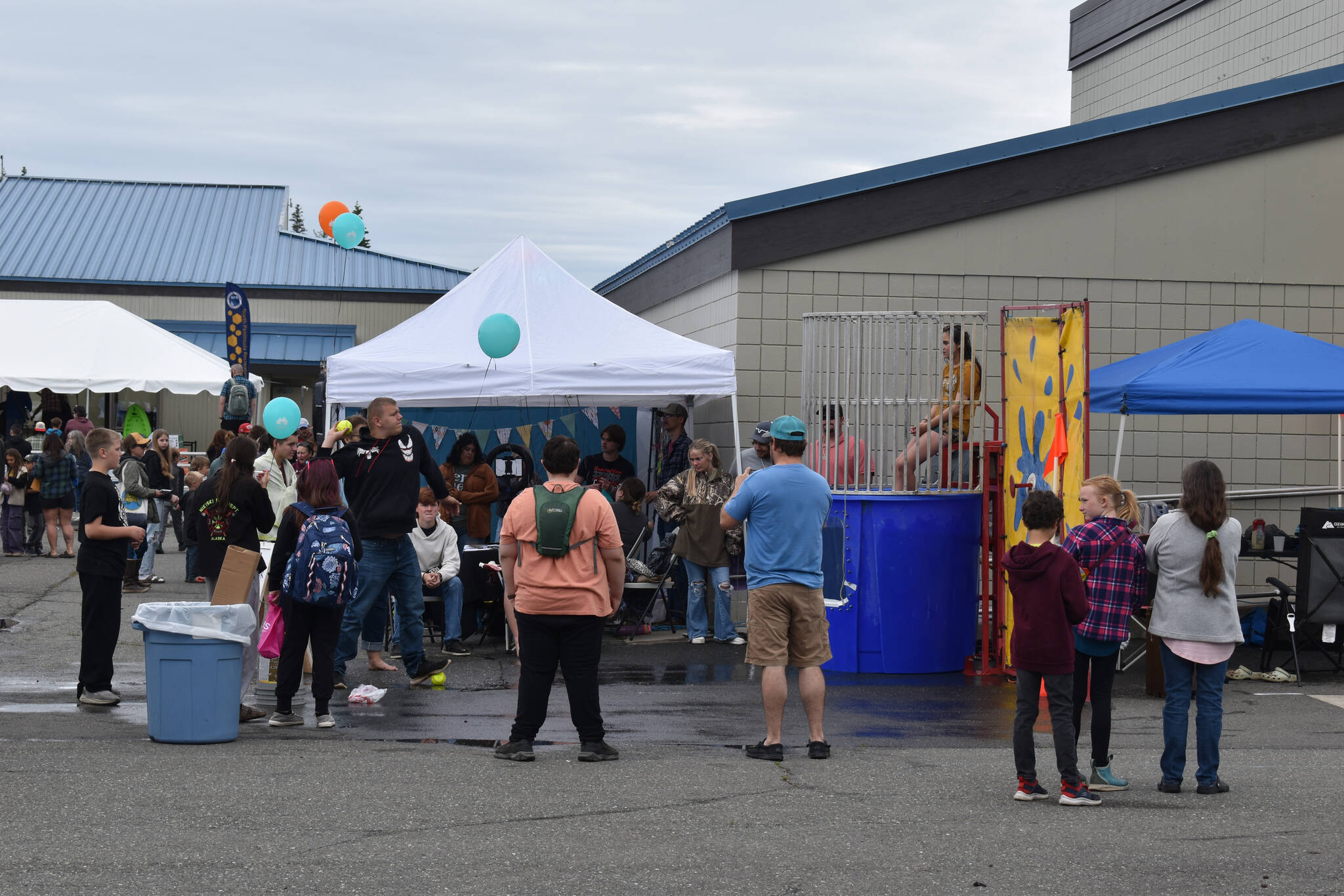 Man throws a ball toward the dunk tank during the Family Fun in the Midnight Sun festival at the North Peninsula Recreation Center in Nikiski, Alaska, on June 21, 2025. (Photo by Jonas Oyoumick/Peninsula Clarion)