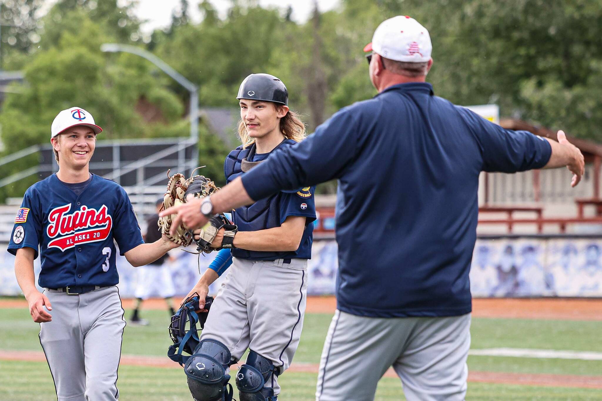 Malakai BeDunnah and Ari Miller of the American Legion Post 20 Twins are congratulated by head coach Robb Quelland on Saturday, June 28, 2025, at the Alaska 529 Midseason Classic at Mulcahy Stadium in Anchorage, Alaska. (Photo by Stephanie Burgoon/Alaska Sports Report)