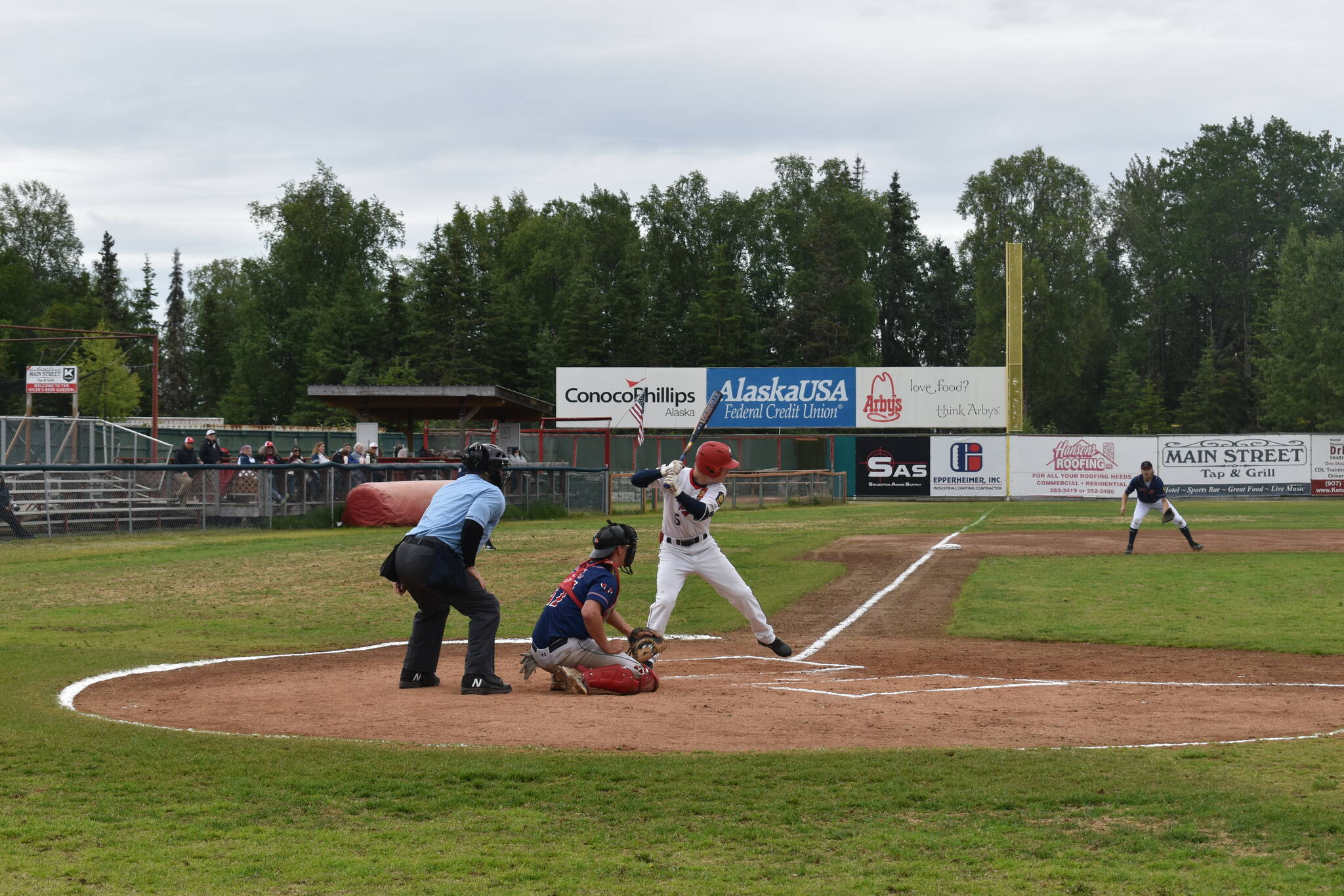 Daniel Steffensen bats against the Post 35 Road Warriors on Saturday at Coral Seymour Memorial Park as part of the 100th anniversary of American Legion Baseball in Alaska. (Jonas Oyoumick/Peninsula Clarion)