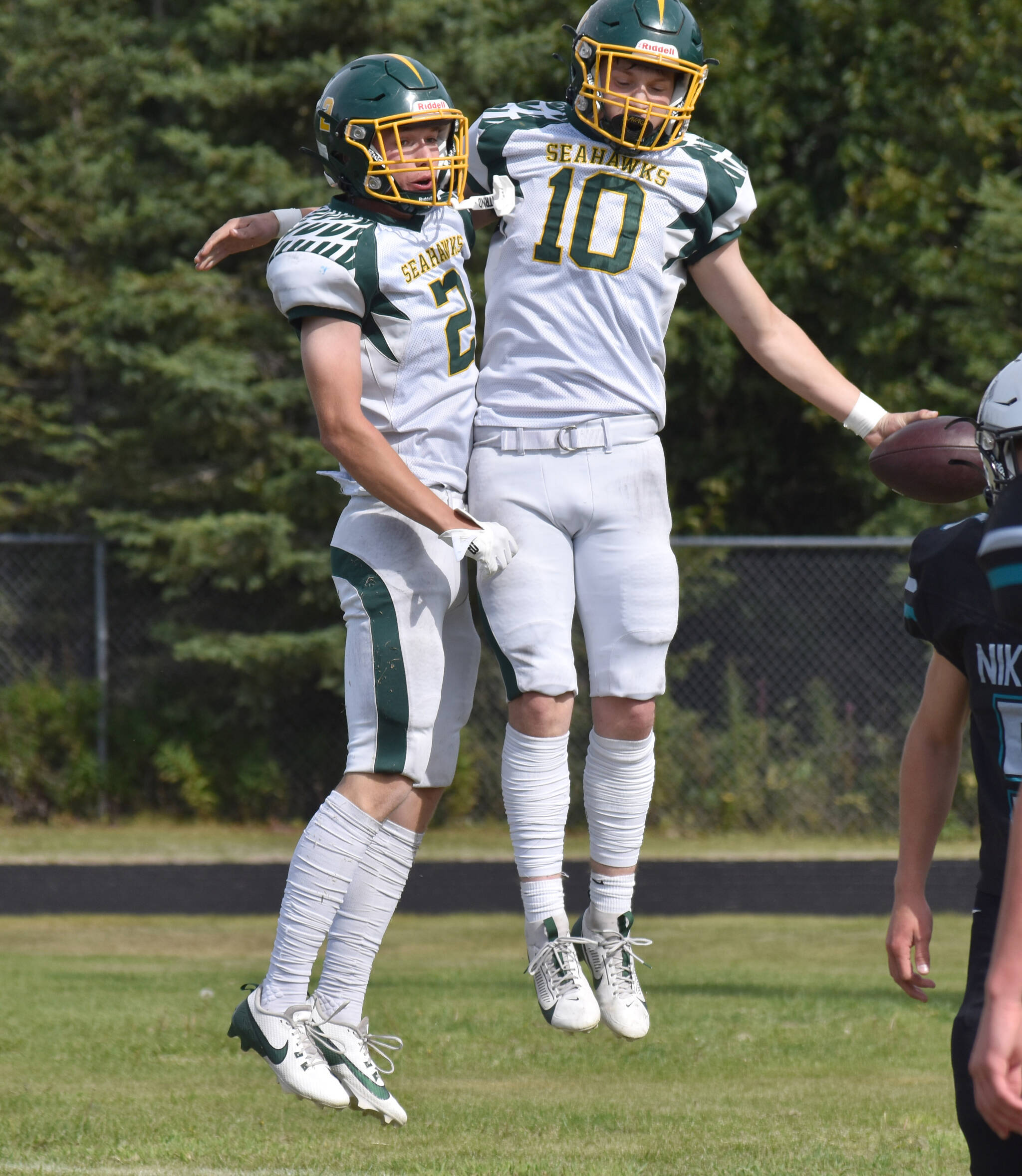 Seward’s Lane Petersen and Emerson Cross celebrate a touchdown Saturday, Aug. 16, 2025, at Nikiski Middle-High School in Nikiski, Alaska. (Photo by Jeff Helminiak/Peninsula Clarion)