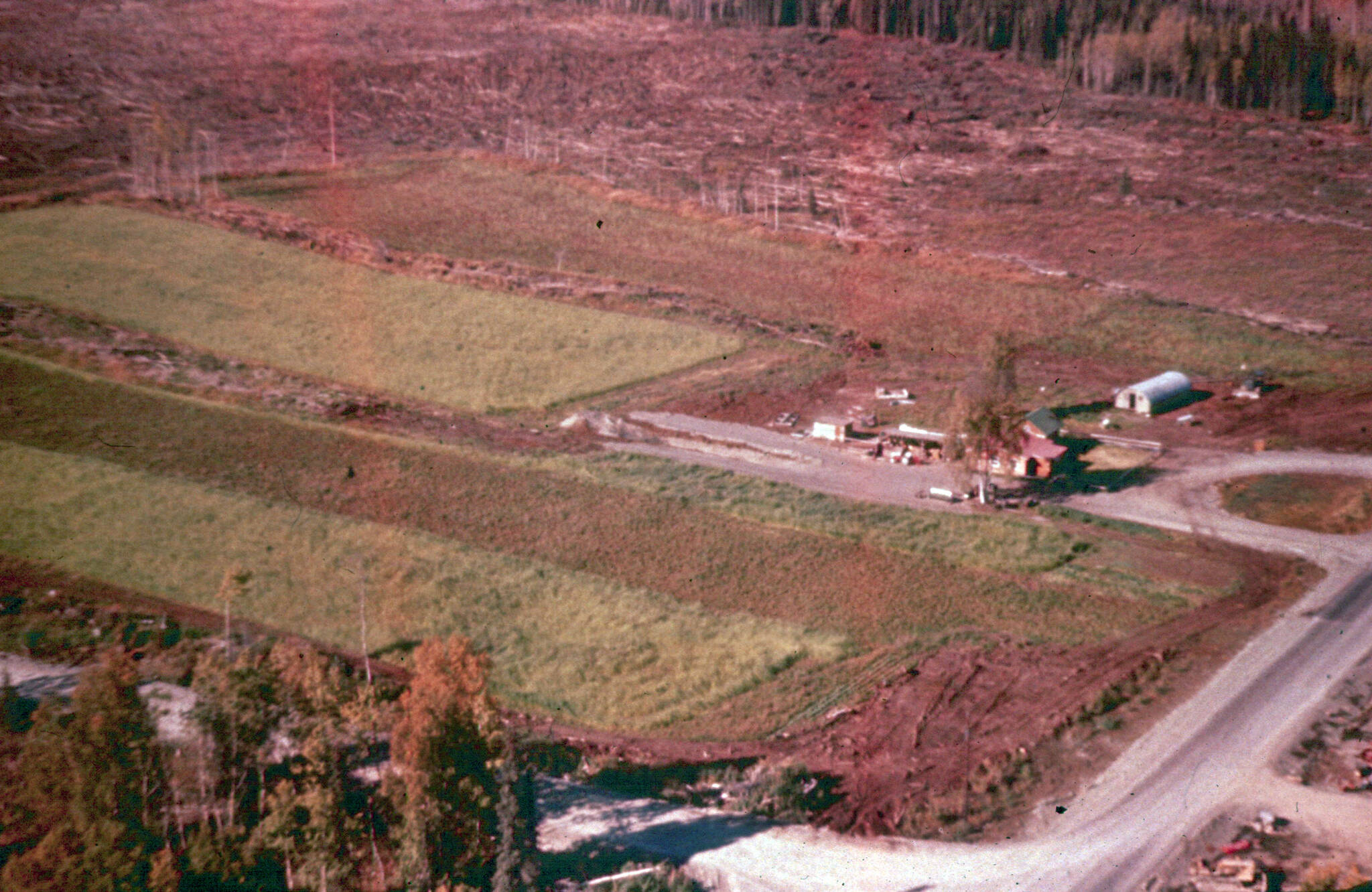 This 1955 aerial shows a portion of Joe and Mickey Faas homestead, including the Quonset hut that was on the property before it was acquired by Howard and Maxine Lee in 1948. The fields and other cleared land now house much of Soldotnas growing medical establishment. (Photo courtesy of Al Hershberger)