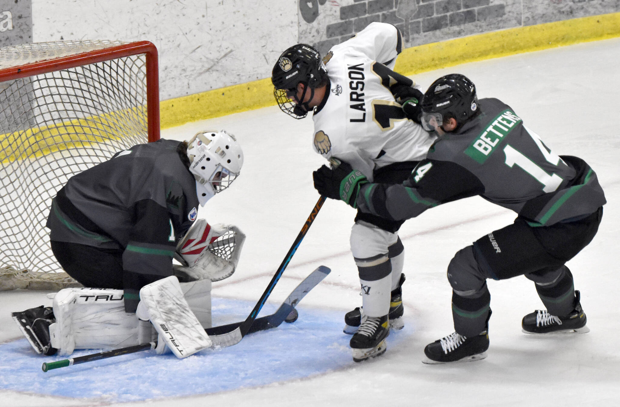 Minnesota Wilderness goalie Adam Prokop stops Andy Larson of the Kenai River Brown Bears in front of Nolan Bettens of the Wilderness on Friday, Oct. 13, 2023, at the Soldotna Regional Sports Complex in Soldotna, Alaska. (Photo by Jeff Helminiak/Peninsula Clarion)