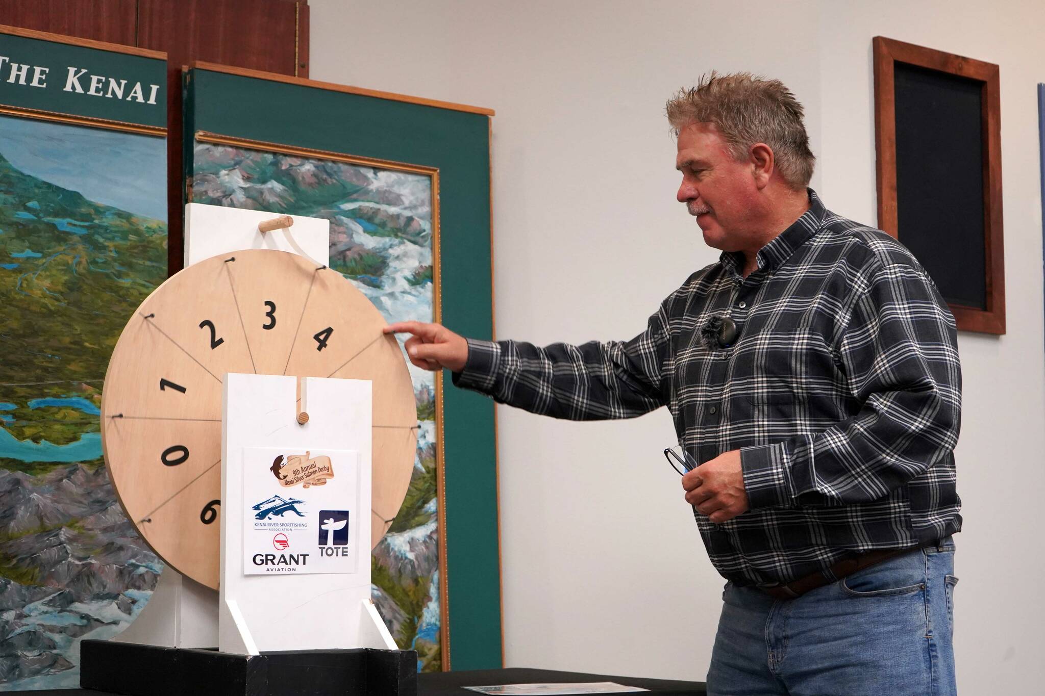 Kenai Mayor Brian Gabriel spins the wheel to determine the magic weight for the first day of the Ninth Annual Kenai Silver Salmon Derby at the Kenai Chamber of Commerce in Kenai, Alaska, on Tuesday, Sept. 9, 2025. (Jake Dye/Peninsula Clarion)