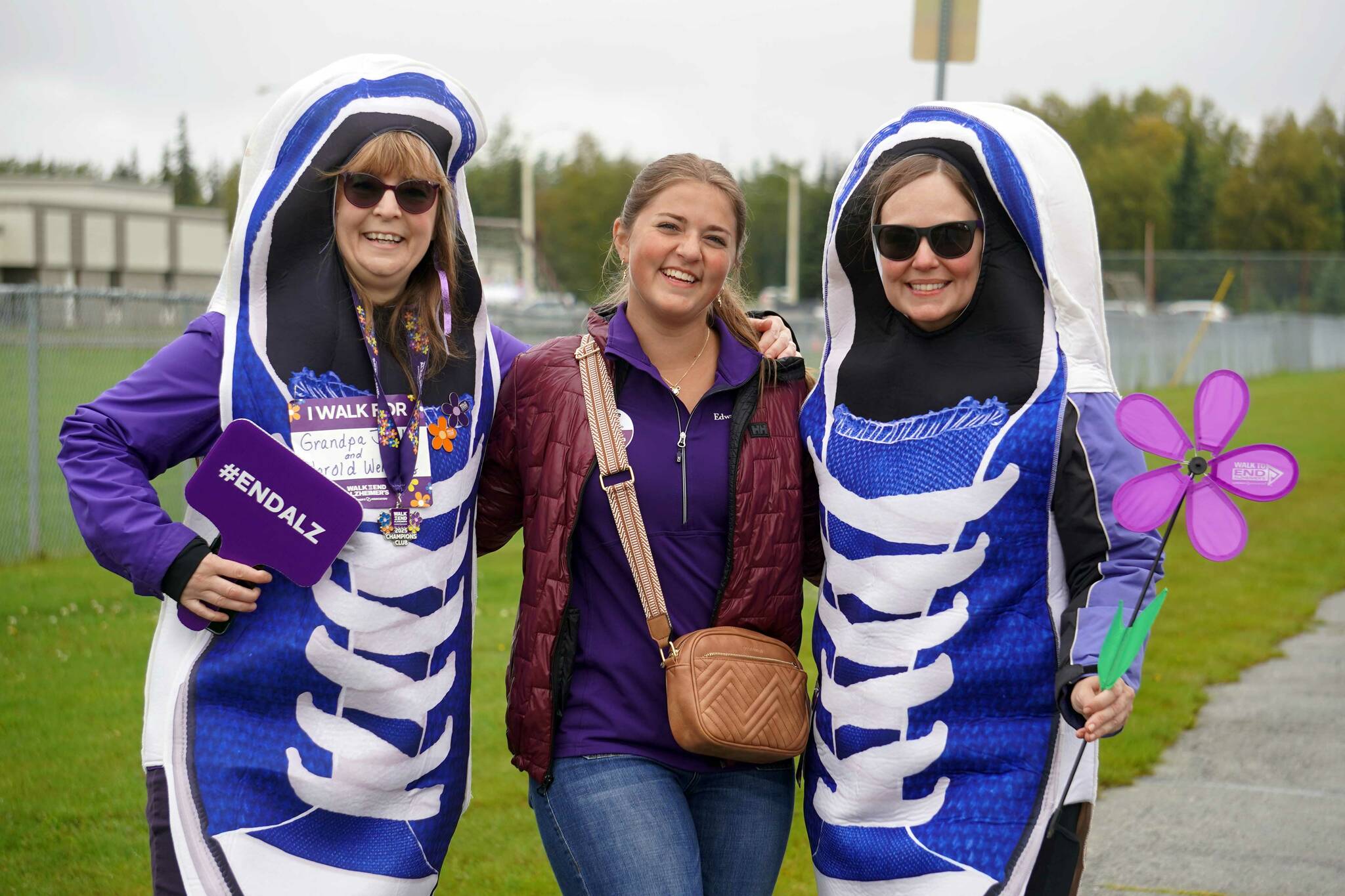 Sara Hondel, Anna DeVolld and Heidi Sorrell stand for a photo during the Third Annual Kenai Peninsula Walk to End Alzheimer’s on North Tinker Lane in Kenai, Alaska, on Saturday, Sept. 13, 2025. (Jake Dye/Peninsula Clarion)