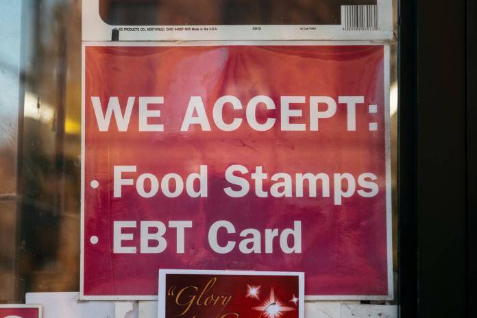 A sign for a store that accepts food stamps and exchange benefits transfer cards is seen in this 2019 photo. (Photo by Scott Heins/Getty Images via Alaska Beacon)