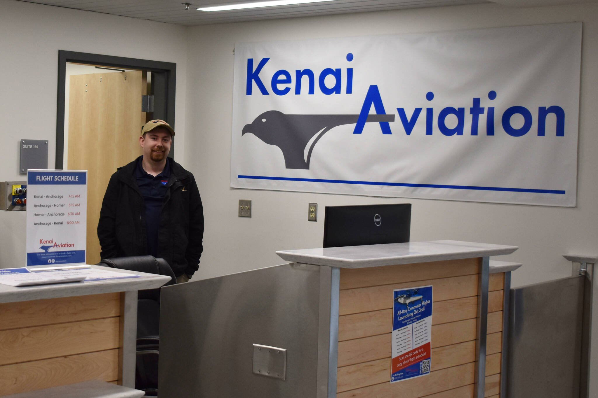 Jacob Caldwell, chief executive officer of Kenai Aviation, stands at the Kenai Aviation desk at the Kenai Municipal Airport on Thursday, Sept. 13, 2022 in Kenai, Alaska. (Jake Dye/Peninsula Clarion)