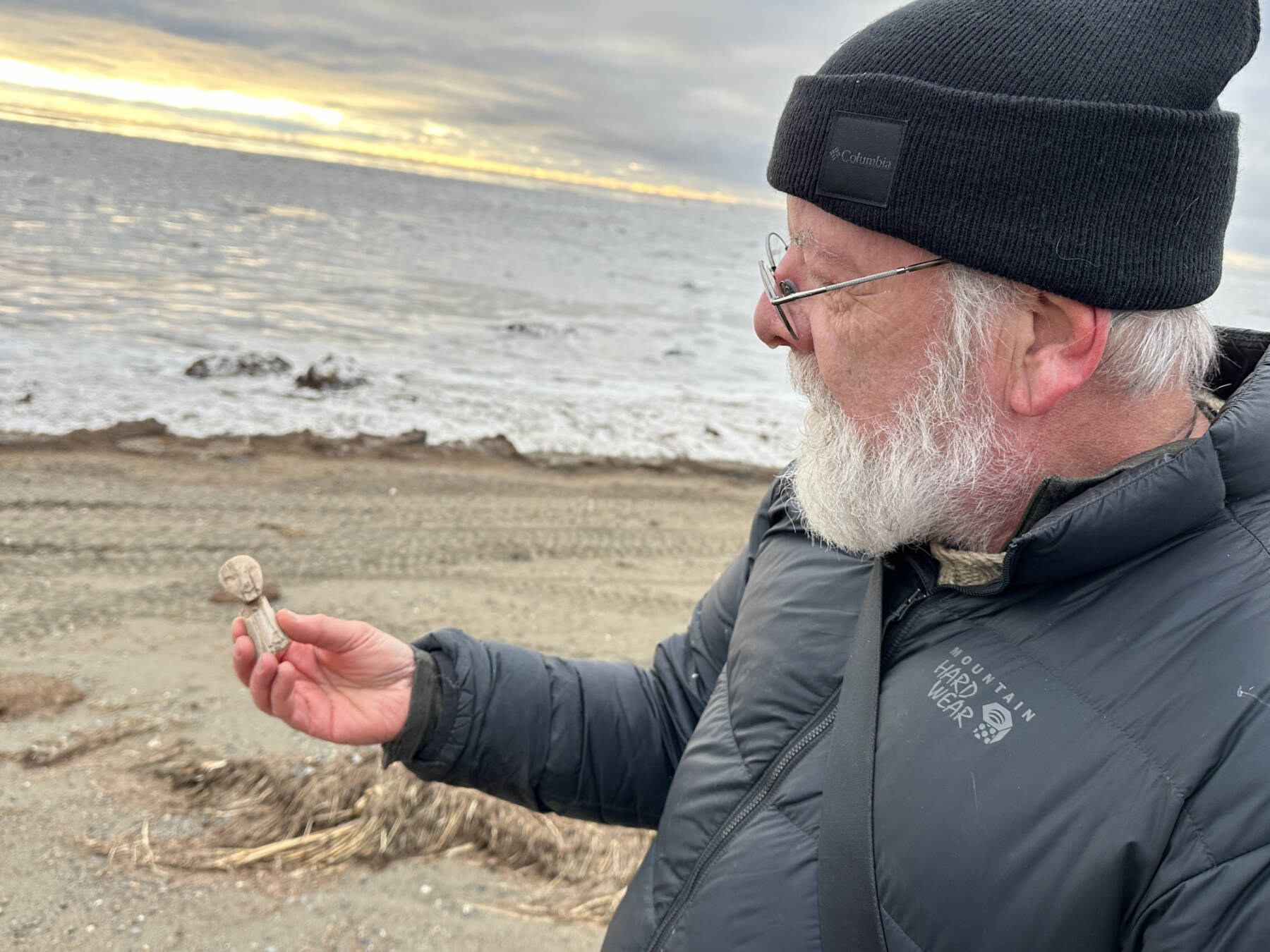 Archaeologist Rick Knecht holds a human figure that he found on the beach near the village of Quinhagak on Oct. 24, 2025. Photo courtesy Alice Bailey