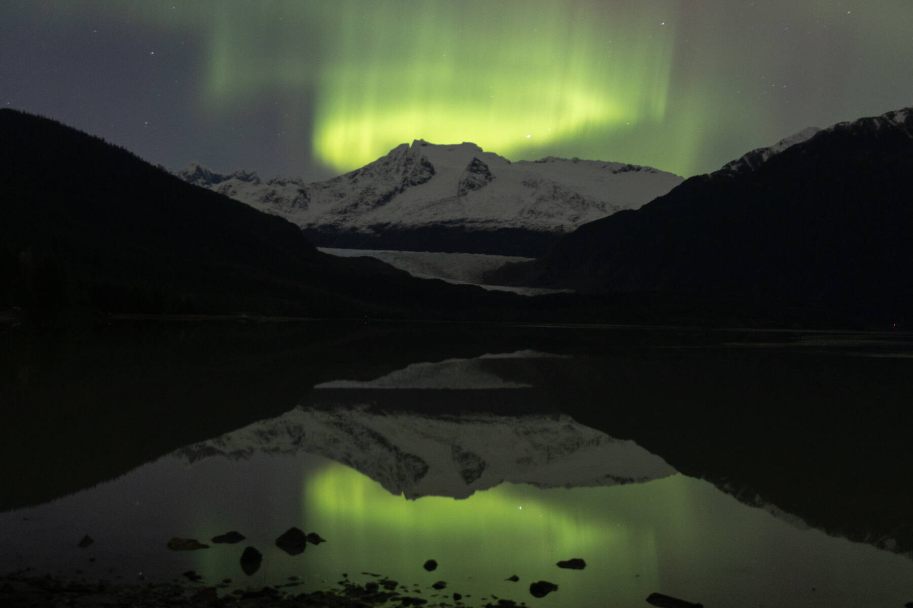 The aurora borealis dances over the Mendenhall Glacier in Juneau on Nov. 12<ins>, 2025</ins>. Hundreds of Juneauites flocked to dark areas of town to catch particularly strong performances from the northern lights due to a series of solar flares Tuesday and Wednesday nights. (Chloe Anderson/Peninsula Clarion)