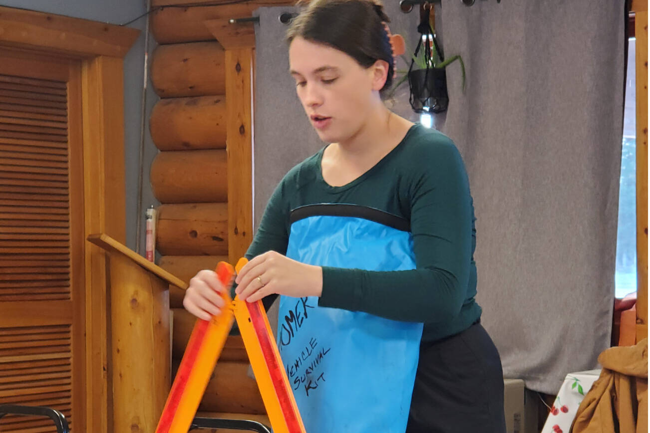 Homer public health nurse Emily Sears demonstrates tools in her vehicle emergency supply kit during a presentation on winter storm preparedness at the Anchor Point Senior Center on Thursday, Nov. 20, 2025, in Anchor Point, Alaska. (Delcenia Cosman/Homer News)