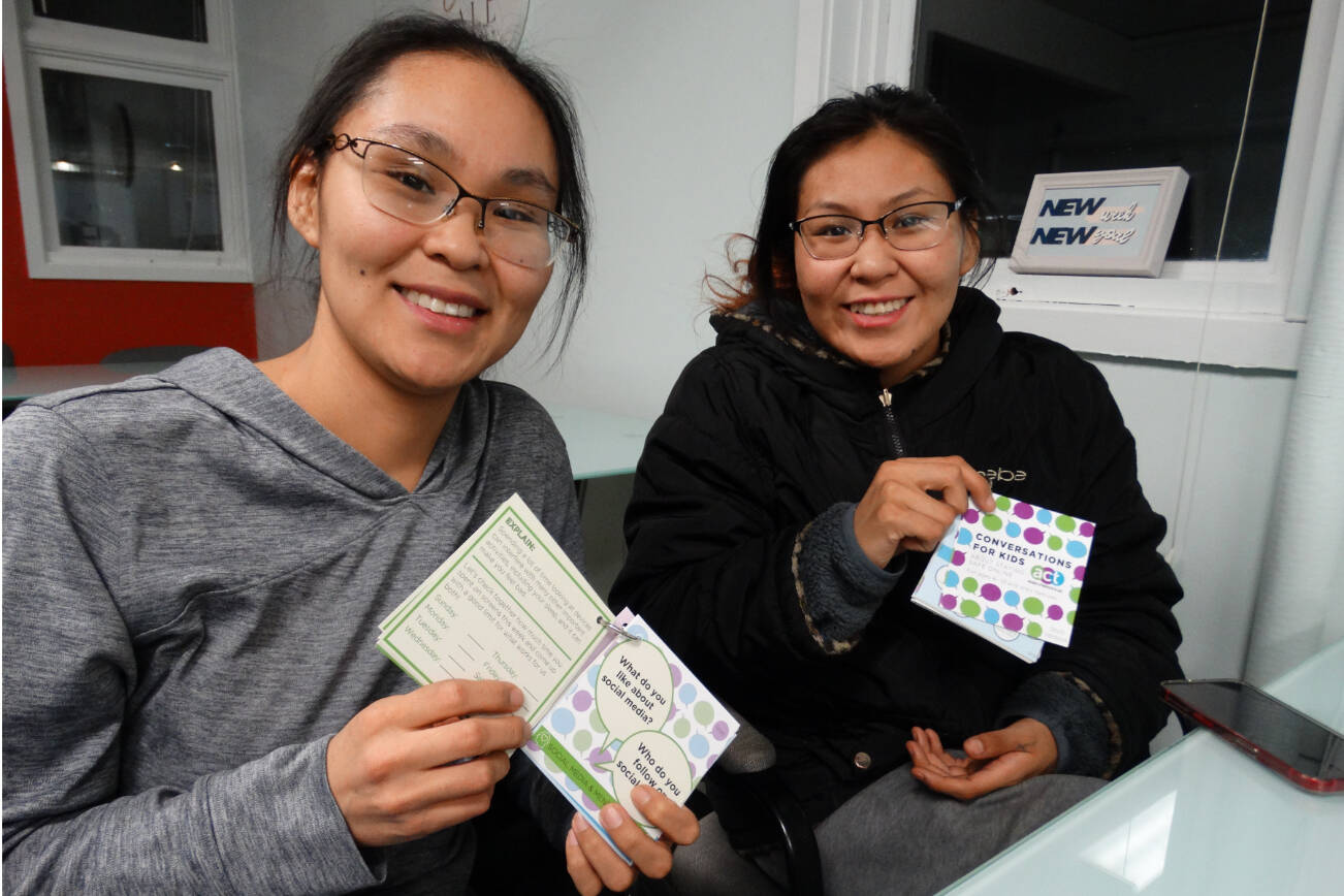A parent and teen use conversation cards created by the Alaska Children's Trust. Photo courtesy Kaila Pfister