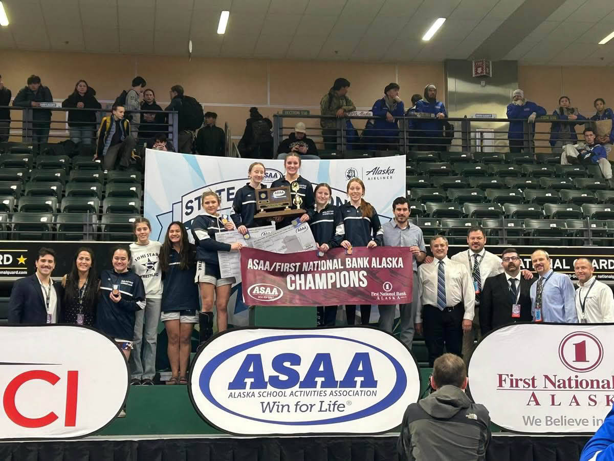 Photo courtesy of Andie Bock/Andies Alaskan Adventures Photography
The Soldotna High School girls wrestling team stands on the podium after winning the state championships in Anchorage on Dec. 20. The girls won their third state title in a row, securing the programs first ever three-peat victory.