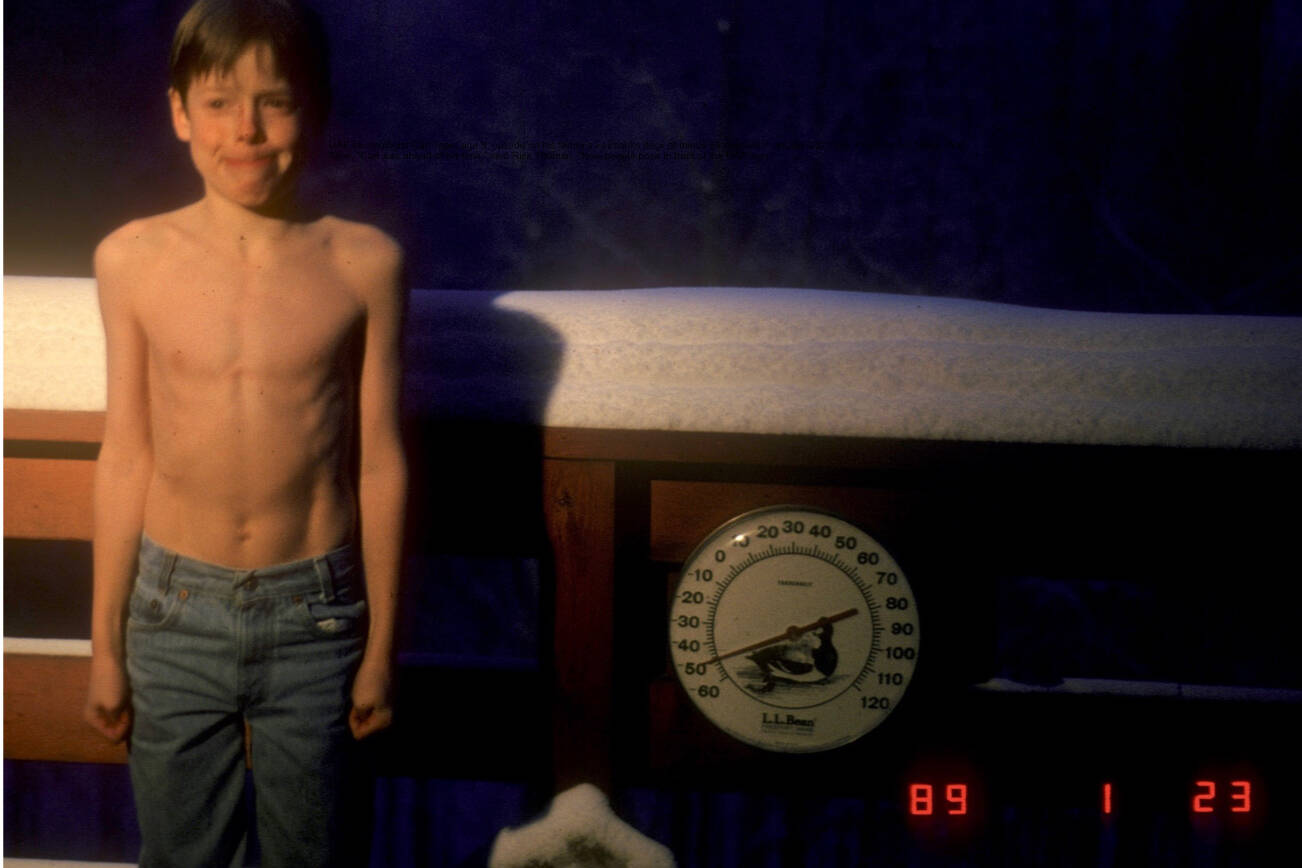 UAF seismologist Carl Tape, age 9, stands outside on his family’s Fairbanks deck at minus 50 degrees F on Jan. 23, 1989. “Carl was ahead of his time,” said Rick Thoman. “Now people pose in front of the UAF sign.” Photo courtesy Walt Tape