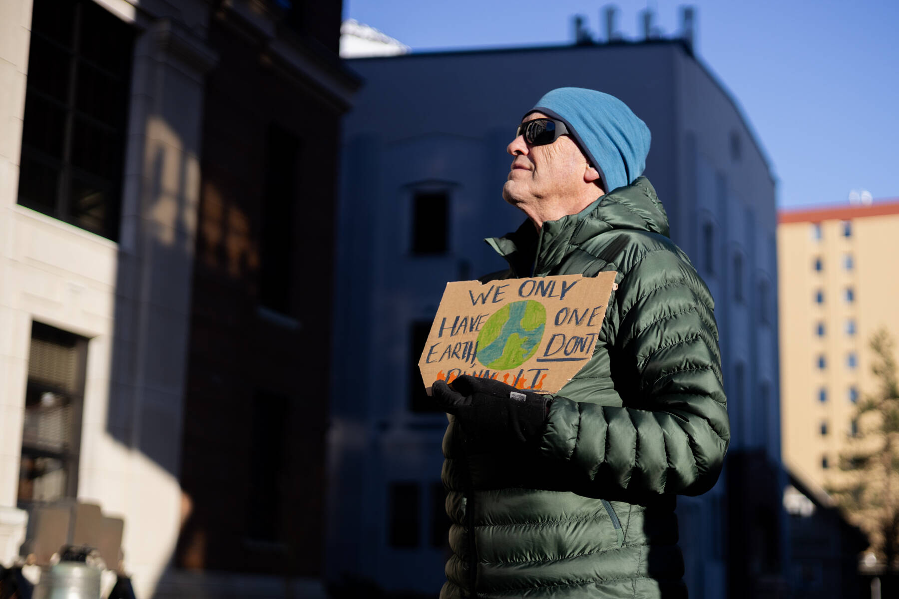 Photos by Chloe Anderson / Juneau Empire
Jeff Wilson holds a sign reading We only have one Earth, dont burn it during a protest led by the Juneau-Douglas High School: Yadaa.at Kalé chapter of Alaska Youth for Environmental Action outside the Alaska State Capitol on Saturday, Jan. 24<ins>, 2026</ins>.