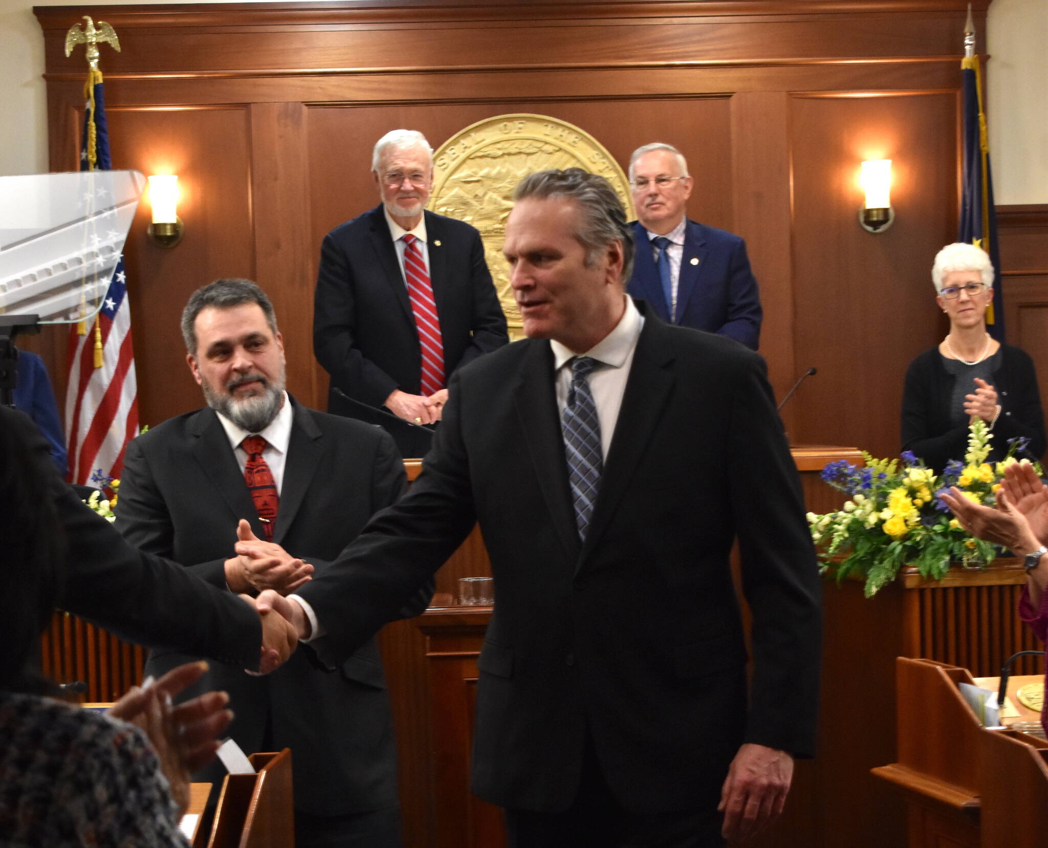 Governor Dunleavy shakes hands with a representative as he exits from his final State of the State address on Thursday evening, Jan. 22, 2026. (Mari Kanagy/Juneau Empire)