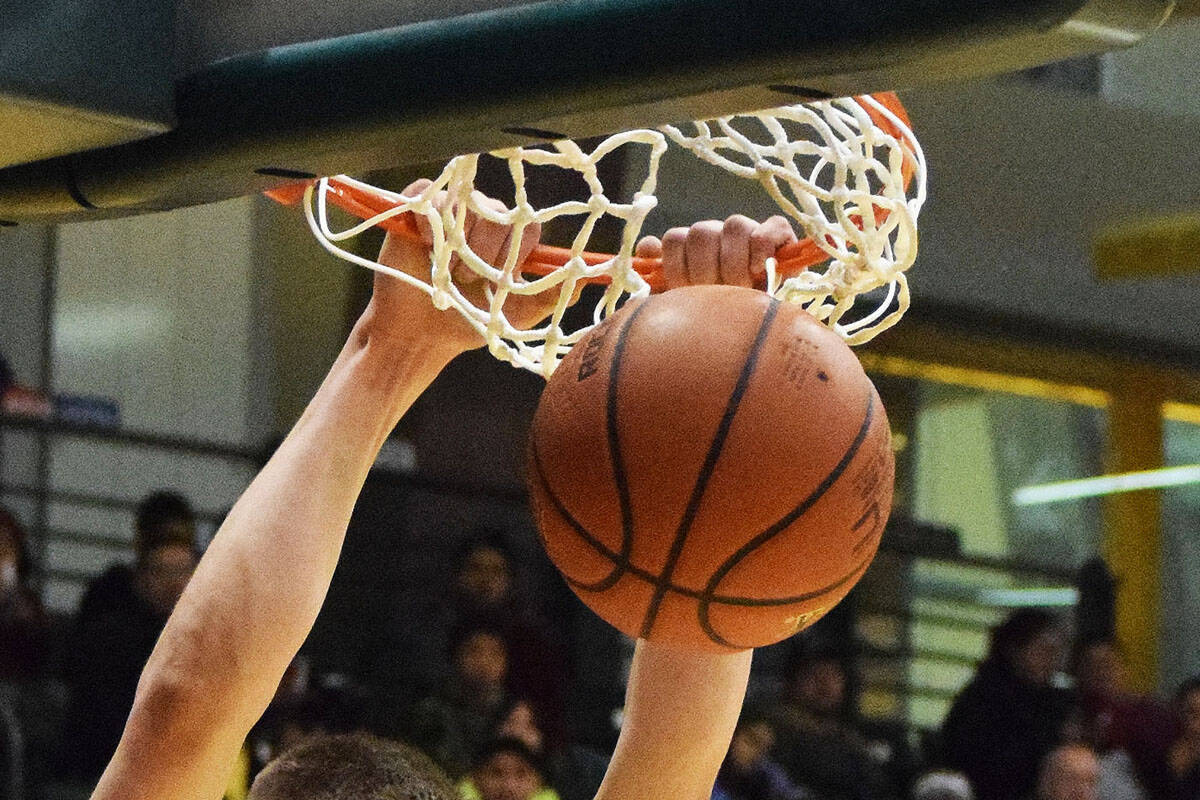 Ninilchiks Austin White puts down a two-handed dunk against the Aniak Halfbreeds Wednesday at the Class 1A state basketball tournament at the Alaska Airlines Center in Anchorage. (Photo by Joey Klecka/Peninsula Clarion)