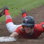 Twins catcher Cody Quelland tags to first base June 15, 2018, against Service at Coral Seymour Memorial Ballpark in Kenai. (Photo by Joey Klecka/Peninsula Clarion)