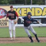 Chugiak/Eagle River Chinooks baserunner Luke VanDover tries to time a move with Peninsula Oilers shortstop Bryan Woo watching closely Friday night at Coral Seymour Memorial Park in Kenai. (Photo by Joey Klecka/Peninsula Clarion)