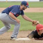 Peninsula Oilers shortstop Evan Berkey slides under the tag of Chugiak-Eagle River Chinooks first baseman Danny Dopp on Sunday, June 24, 2018, at Coral Seymour Memorial Park in Kenai. (Photo by Jeff Helminiak/Peninsula Clarion)