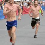 Anchorages Lars Arneson, a 2009 graduate of Cook Inlet Academy, passes Sewards Erik Johnson to take seventh place at the Mount Marathon Race on July 4, 2018, in Seward. Johnson finished eighth.(Photo by Jeff Helminiak/Peninsula Clarion)