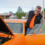 Jim McEwen steps into the classic car he restored at Autozone on Saturday, June 30, 2018 in Soldotna, Alaska. McEwen is a member of the Kaknu Kruzers, a local club composed of members who restore classic cars. The club has a number of events and rives throughou the summe, including the upoming car show at the Soldotna Progress Days parade on July 28. (Photo by Elizabeth Earl/Peninsula Clarion)