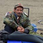 Anchorage resident Mike Wolford rests on Kenai Beach Tuesday, June 10, 2018, during the first day of dipnetting season in Kenai, Alaska. Wolford, who traveled with a friend to join in the dipnetters, had caught on salmon by mid-afternoon. (Photo by Erin Thompson/Peninsula Clarion)