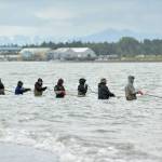 Dipnetters wade into the Cook Inlet in hopes of catching salmon on the first day of dipnetting season on Tuesday, July 10, 2018, in Kenai, Alaska. (Photo by Erin Thompson/Peninsula Clarion)