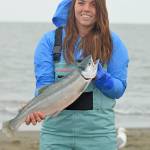 Alaina Hager shows off her catch on Kenai Beach during the first day of the three-week dipnetting season on July 10, 2018, in Kenai, Alaska. Hager, who was dipnetting for the first time, had caught two salmon and a flounder by mid-afternoon Tuesday. (Photo by Erin Thompson/Peninsula Clarion)