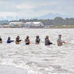 Dipnetters cast their nets along the shore of Kenai Beach on the opening day of the three-week dipnet season on Tuesday, July 10, in Kenai, Alaska. (Photo by Erin Thompson/Peninsula Clarion)